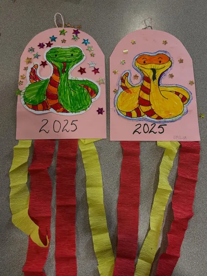 The finished snake crafts, complete with sparkly stars and crepe paper tails. They make for wonderful decorations.