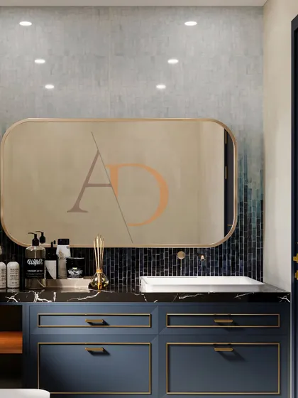 A close-up of a navy blue vanity with gold profile handles, set against a custom Kit Kat mosaic tile wall with a beautiful ombre effect.