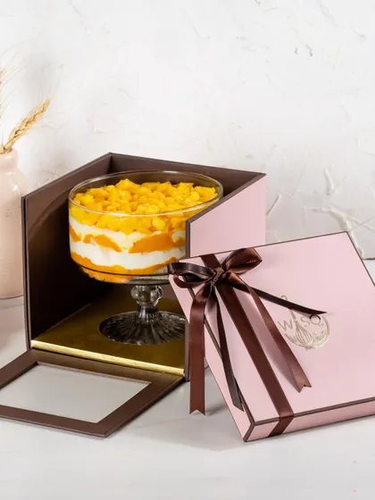 Our Mango Cream Cheese Trifle, a seasonal favourite, packaged in its pink single gift box. The packaging ensures this delicate dessert travels safely and arrives beautifully.