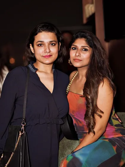 Two friends posing together, part of the cool crowd at my favorite rooftop spot.