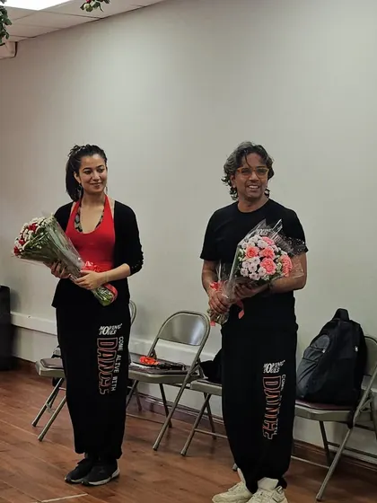 Our instructors holding bouquets after conducting the workshop at the American Embassy School.
