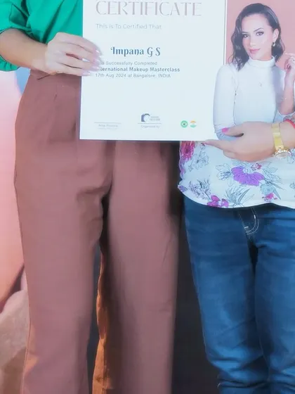 Holding my certificate from the Nidy Roseira International Makeup Masterclass. This represents my dedication to learning and bringing the best makeup education to my students.