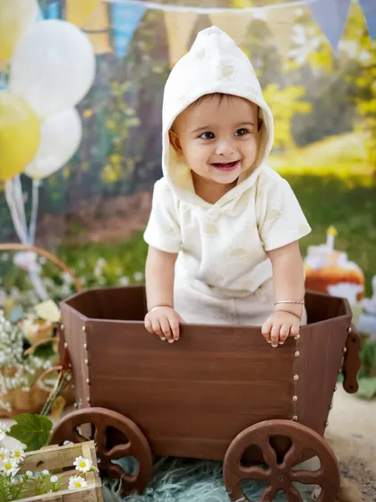 Another joyful shot from the rustic birthday session, with balloons in the background adding to the celebratory feel.