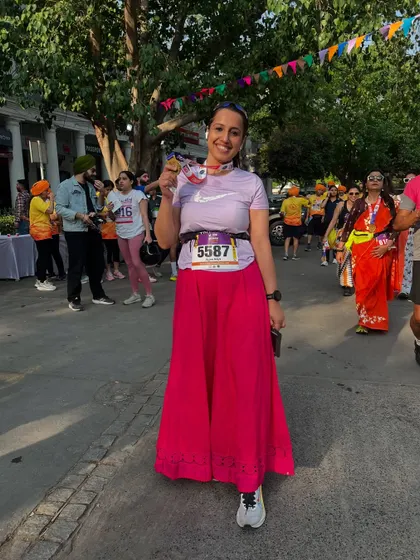 A runner proudly showing off her medal after the Vaisakhi 5K. The joy and sense of accomplishment after an event like this is what it's all about.