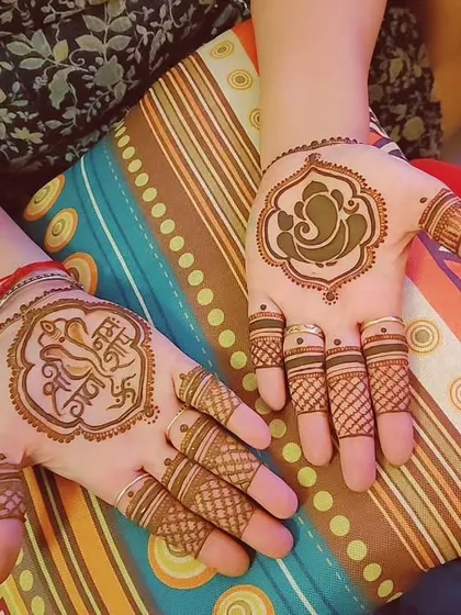 A simple and spiritual Ganesh Chaturthi design, with a Ganesha motif on one palm and a mantra on the other.