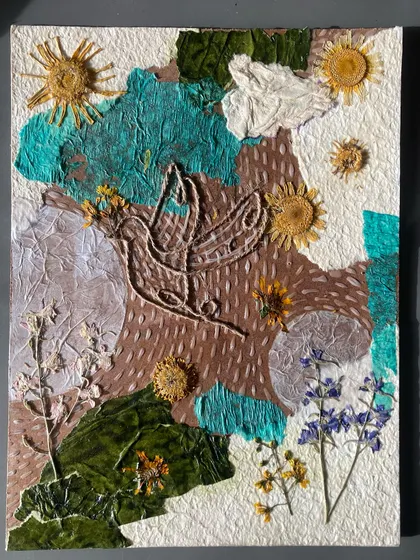 This student incorporated dried flowers and leaves directly into their collagraph plate. This technique, combined with string and textured paper, creates a wonderfully organic and multi-layered piece of art.