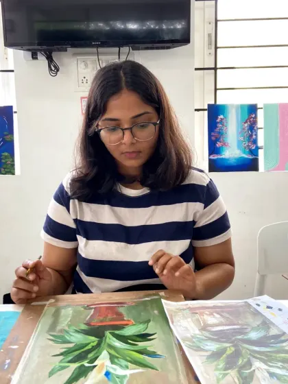 A student in our acrylics course working on a pineapple painting. The courses allow you to explore different subjects and styles.