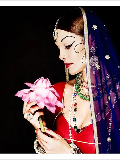A modern interpretation of traditional Indian beauty. The sharp, graphic eyeliner and classic bridal attire create a look that is both respectful of heritage and artistically forward-thinking.