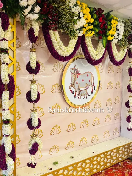 Another angle of the cow-themed backdrop, showing the combination of a lotus-patterned wallpaper and a gold geometric frame. This blend of elements creates a rich and layered look.