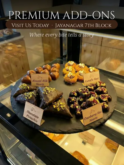 Almond Milk Hearts, Kunafa Nest, Chocolate Pistachio and Cranberry Nut Hearts are arranged in our counter display.