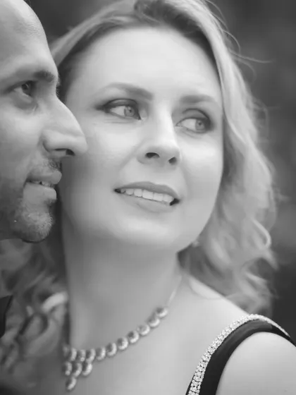 A soft-focus, artistic black and white close-up. This pre-wedding shot emphasizes the bride-to-be's expression, creating a dreamy and romantic mood.