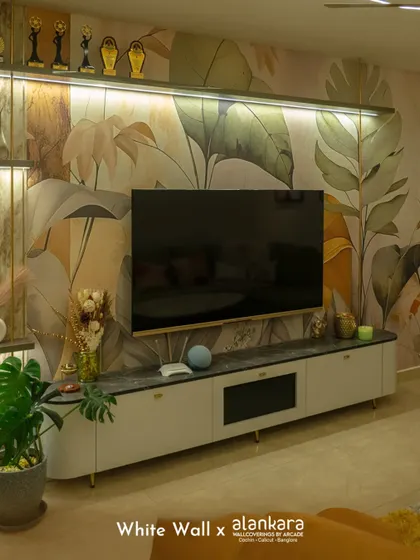 I believe walls are a canvas for art. Here, a custom botanical wallpaper from my collection serves as a stunning backdrop for a sleek, modern television unit, demonstrating how I integrate technology and nature-inspired design seamlessly.