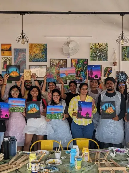 A group of proud painters with their finished canvases. It's always rewarding to see everyone's hard work pay off.