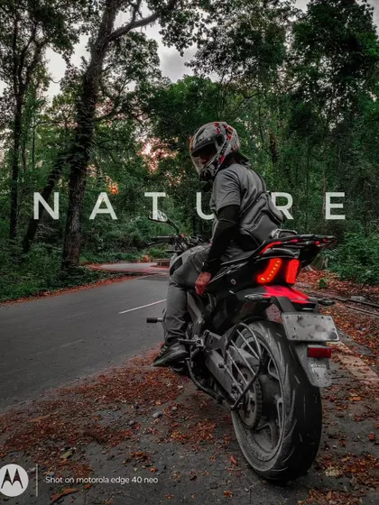 A rider taking a break on a scenic forest trail, a perfect example of our nature-focused adventure rides.
