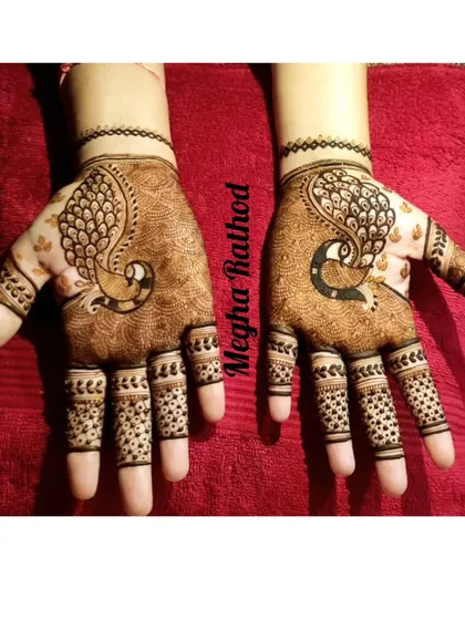 A simple and elegant back-of-hand design featuring graceful peacock motifs. The minimal use of patterns on the fingers keeps the focus on the central design.