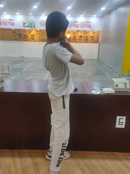 A young shooter learning the correct standing posture. Our basic courses cover all the fundamentals, from safety rules to proper shooting techniques.