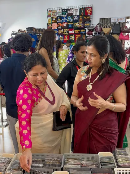 Interacting with a customer at my stall in Suryavanshi Hall, Dadar. I love helping clients find the perfect piece.