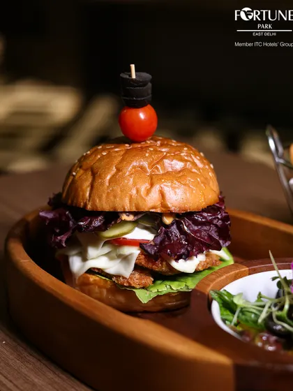 Our juicy gourmet burger, stacked high with fresh lettuce, cheese, and a perfectly cooked patty, is a satisfying choice for any meal.