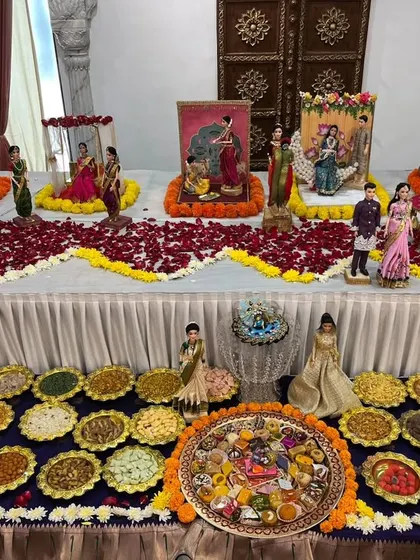 A beautiful table display for a baby shower, combining our detailed doll rukhwat with a lavish spread of traditional Maharashtrian 'khau' or snacks.