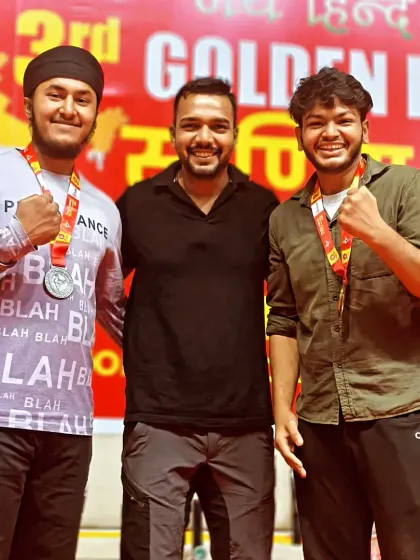 Posing with two of my medal-winning fighters at the Golden Bharat Kickboxing Cup. Their success is a testament to their hard work.