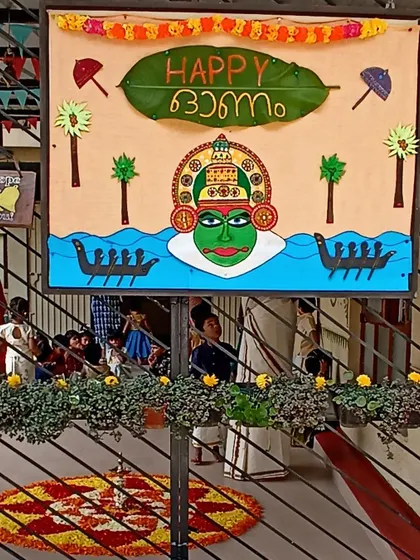 Our vibrant Onam decoration board, featuring a Kathakali face and snake boats.