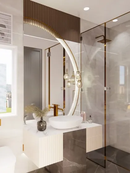A render of a stunningly modern bathroom with a circular backlit mirror, a vessel sink on a floating vanity, and a glass-enclosed shower with gold fixtures.