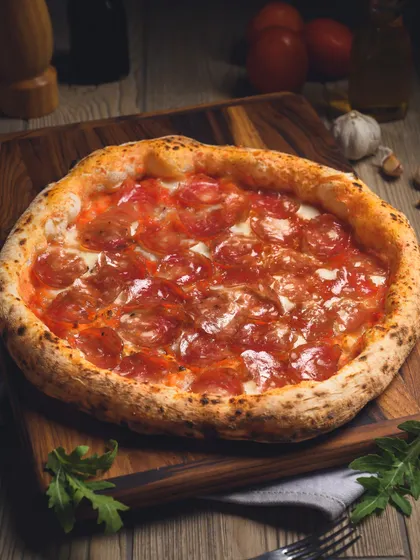 Our Truffle Salami pizza on a wooden board. It's a luxury in every bite.