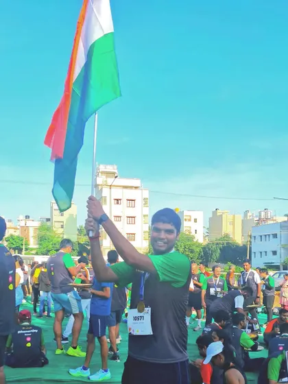 A participant proudly holds the Indian flag after completing the run. Our events are a celebration of fitness, freedom, and national pride.