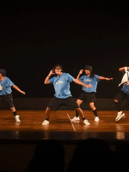 A mid-performance shot of the hip hop team, showcasing their synchronized moves and street-style attitude.