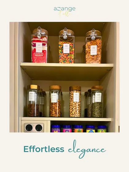 Effortless elegance in the pantry. Clear, labeled jars for snacks and cereals create a clean, uniform look on open shelves.