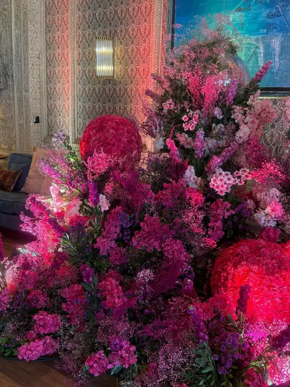 The sheer volume of pink flowers creates a powerful visual impact, turning the space into a garden of romance and celebration.