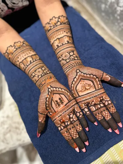 A lovely Teej design with a swing on one palm and a peacock on the other, surrounded by traditional elephant and floral bands.