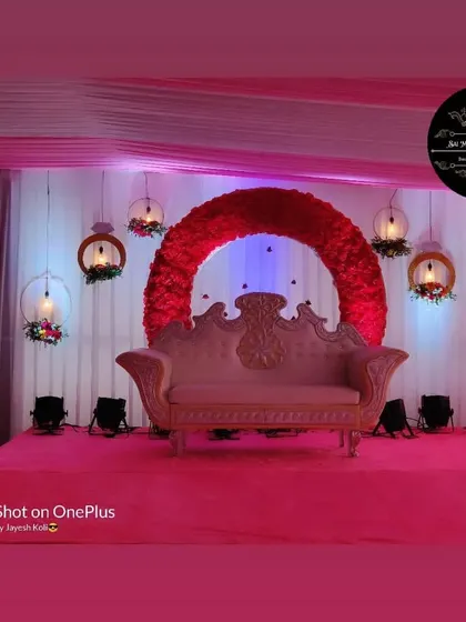 This reception stage features a large red floral ring as the main backdrop. I added hanging decorative lamps and a pink color scheme for the stage and lighting to make it stand out.