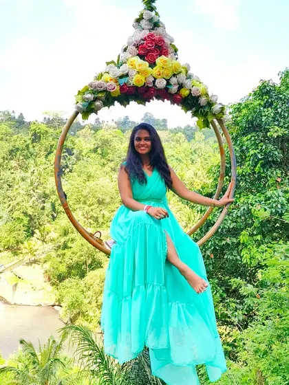 Another beautiful shot on a floral swing, showing the versatility and beauty of this sea green rental gown for any scenic location.