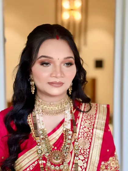 A close-up portrait showcasing the soft glam makeup with a neutral matte lip, which provides a modern touch to her traditional naming ceremony attire.
