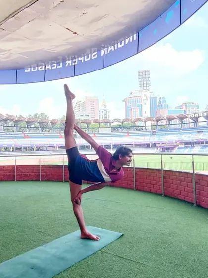 Here I am holding a standing split, or Urdhva Prasarita Eka Padasana, at the Sree Kanteerava Stadium. This posture demonstrates advanced flexibility and balance, key components we develop in my classes.