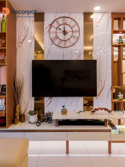 This close-up shows how a simple white console with rose gold legs can be elevated with a marble-finish backdrop and a large, statement wall clock. It's a perfect blend of function and decor.