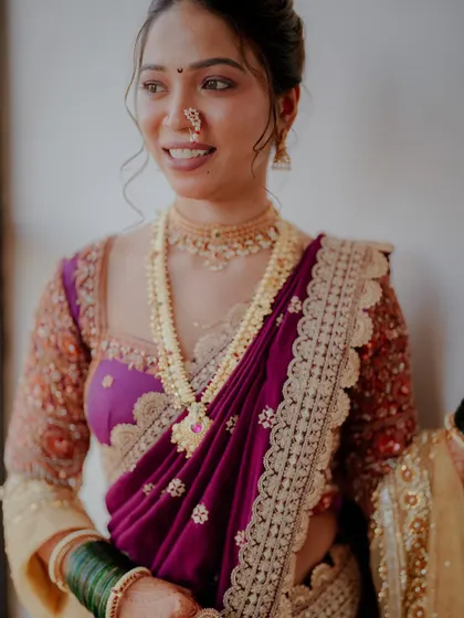 A close-up of the bride's happy expression, showing how the makeup highlights her features, including the traditional nath and bindi.