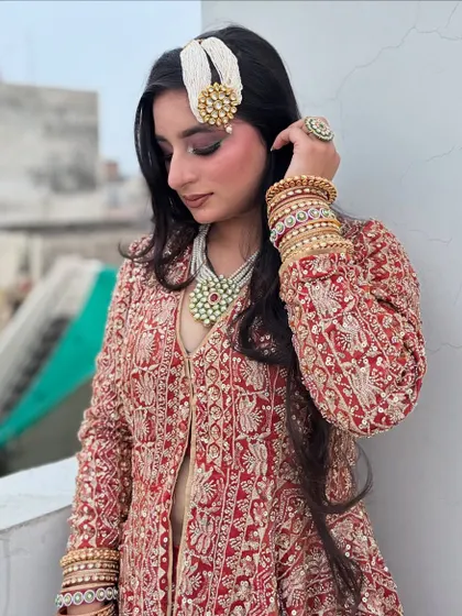 The complete look, featuring a stunning red and gold embroidered jacket, perfect for a winter wedding or a grand reception.