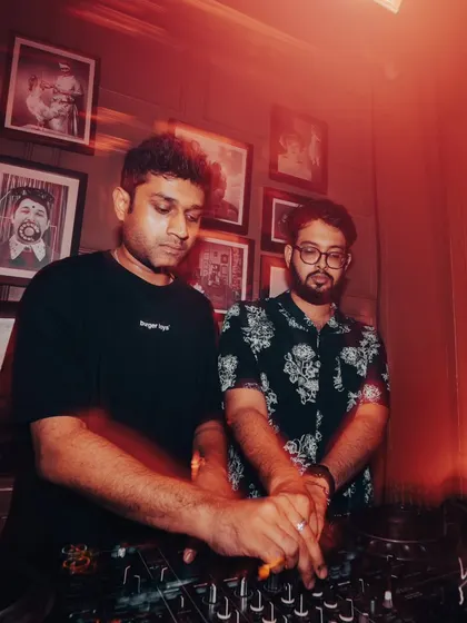 The DJs in their element, crafting the perfect set for the crowd.