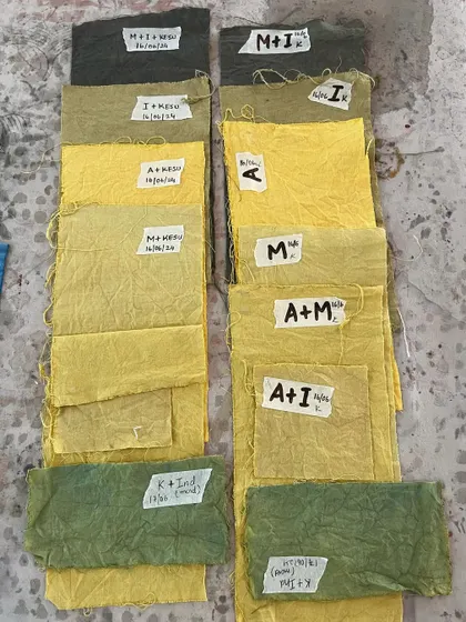 A vibrant array of yellow and green fabric swatches from student experiments. Learning to mix and match natural dyes is a key skill we teach at the academy.