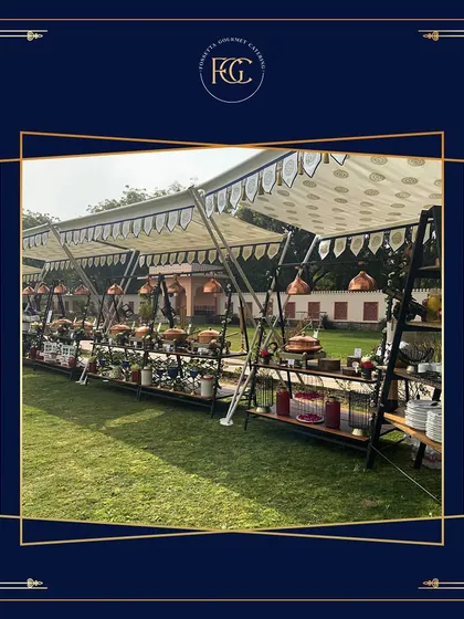 A wide-angle shot of our extensive outdoor buffet setup, showing multiple stations under a tent. This highlights our capacity to handle large-scale events with ease and elegance.