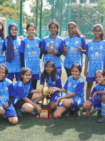 The full squad poses with their runners-up trophy, a proud moment for every player, coach, and supporter of the Blues family.