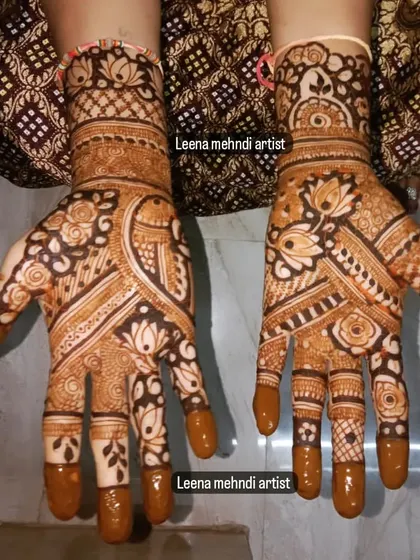 A beautiful, full-coverage design for a wedding guest. The pattern is a mix of floral and traditional Indian motifs, with a rich color from the henna stain.