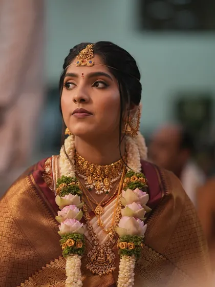 This candid shot during the ceremony shows how the makeup holds up beautifully under different lighting. The focus is on defined eyes and a natural skin finish.