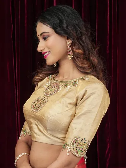 A side view of our gold blouse, showcasing the intricate Zardosi work on the sleeves.