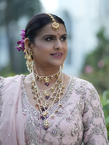 A beautiful portrait showing her glowing skin and confident smile. The makeup is designed to be elegant and timeless.