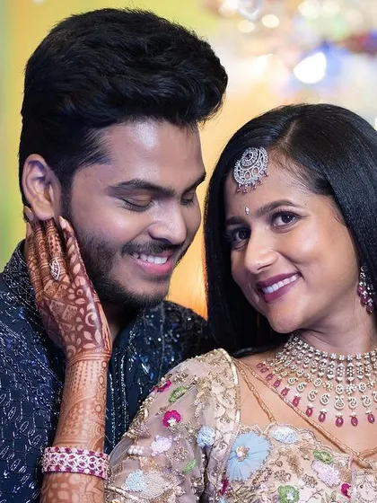 A sweet, intimate moment between the couple. Jagruthi's makeup is soft and romantic, with a focus on glowing skin.