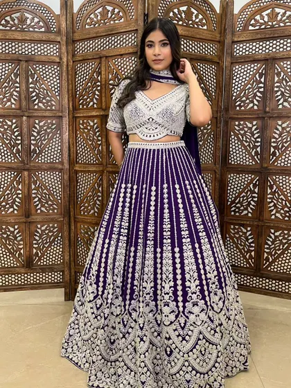 This deep purple lehenga with silver embroidery is a regal and striking choice for an evening function.