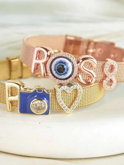 Two distinct styles, one beautiful story. A rose gold bracelet spells out 'ROSS' with an evil eye charm, while the gold one features the letter 'F' and a cute camera charm.